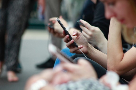 A photograph of a person's hand holding a smartphone